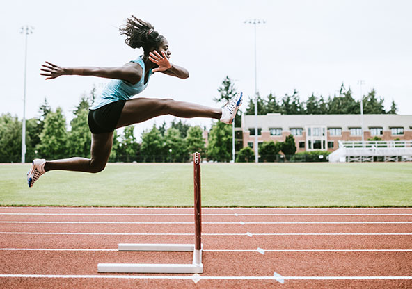 Athlete jumping a hurdle