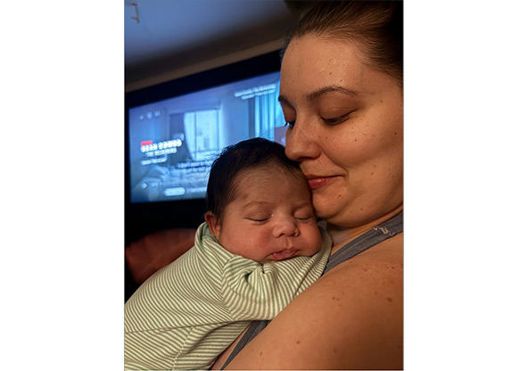 Abigale holding baby Draven at home