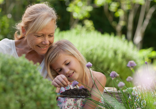 A grandma and her granddaughter gardening together
