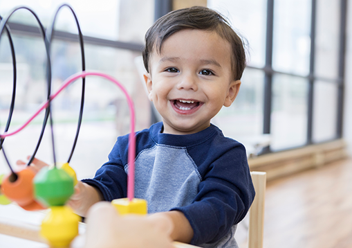 A little boy smiling who has chiari malformation condition 